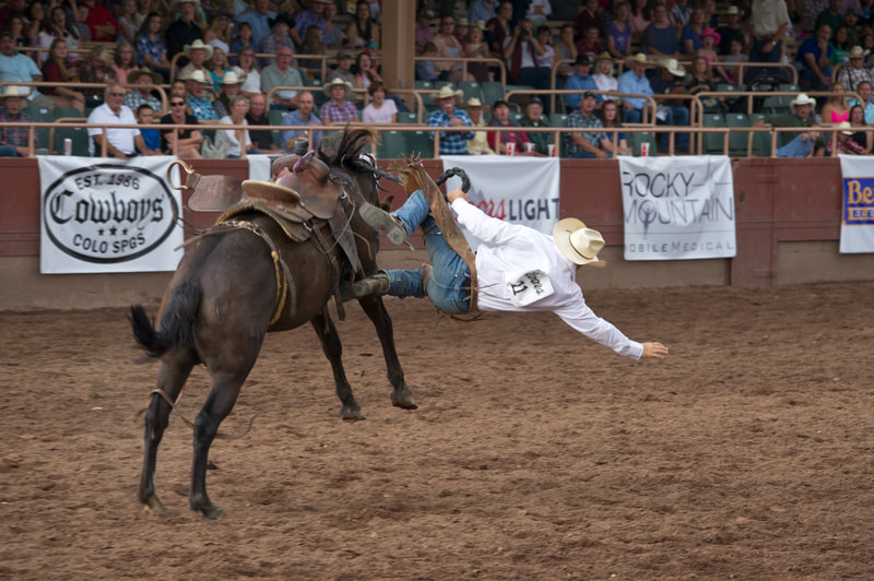 cowboy getting thrown from a horse at the Ride For The Brand Ranch Rodeo cowboy getting thrown from a horse at the Ride For The Brand Ranch Rodeo